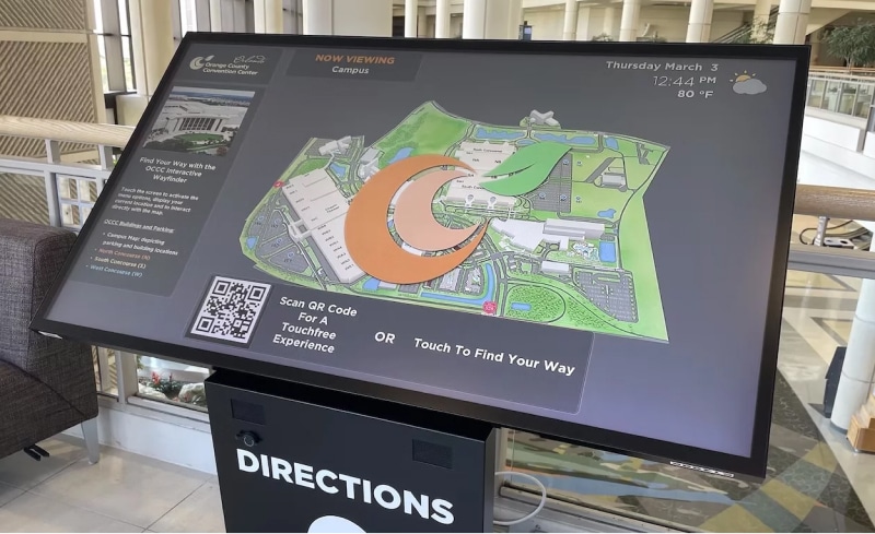 Digital signage screens displaying maps in large facilities